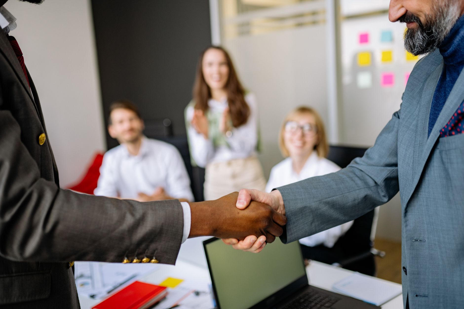 Two people shaking hands over a property deal, representing Dholera developer due diligence